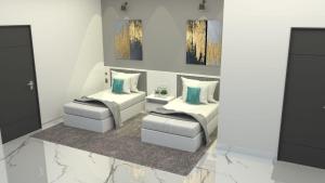 a living room with two beds and a tv at S by Z Hotels, HSR in Bengaluru