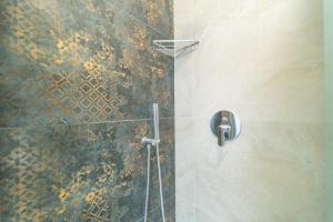 a bathroom with a shower with a rusty wall at Brorent A & L apartment B in Golfo Aranci +18 photos