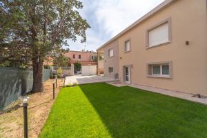 an image of a house with a yard at Brorent A & L apartment T in Golfo Aranci