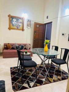 a glass table and chairs in a living room at Tropical VIBES RETREAT in Calangute