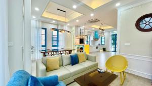 a living room with a couch and a table at Hamster Villa in Bình Tú