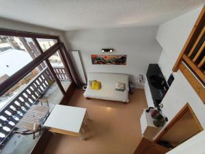 an overhead view of a living room with a balcony at Les Eterlous N44 2P6 in Morillon +1 photo