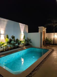 a swimming pool in a backyard at night at Villa in the Heart of Pererenan Prime Location in Munggu +17 photos