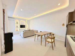 a living room with a table and a couch at Villa in the Heart of Pererenan Prime Location in Munggu