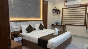 a hotel room with a bed with a large window at Cloud9 Airport Hotel in Nedumbassery