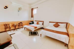 Ένα ή περισσότερα κρεβάτια σε δωμάτιο στο Trúc Hoàng Hà Hotel