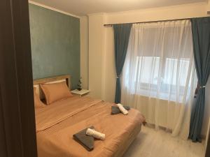 a bedroom with a bed with two towels on it at Central VIP in Craiova