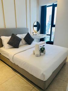 a large bed in a room with a large window at Bukit Bintang Suites KL in Kuala Lumpur