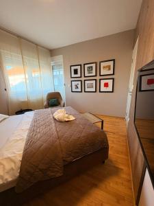 a bedroom with a bed and a chair at NAR Royalton Deluxe Apartment #74 in Niš