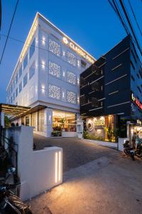a building with lights on the side of it at Hotel Classic Pavilion in Trivandrum