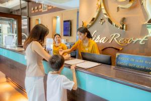 Nipa Resort, Patong Beach في شاطيء باتونغ: امرأة وطفل يطلبان الطعام في مطعم +149 صورة