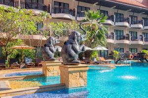 a fountain in the middle of a pool at a hotel at Nipa Resort, Patong Beach in Patong Beach