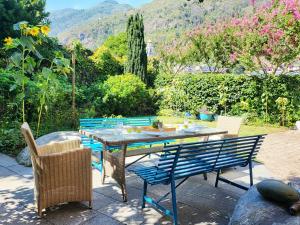 a table and chairs sitting on a patio at Schöne Gartenwohnung am Strand von Tegna Centovalli in Tegna