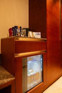 a refrigerator filled with lots of bottles of food at Hotel Classic Pavilion in Trivandrum