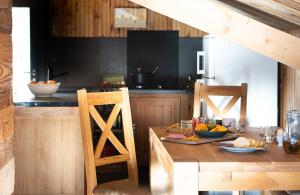 a kitchen with a wooden table with fruit on it at La sittelle in Belvédère