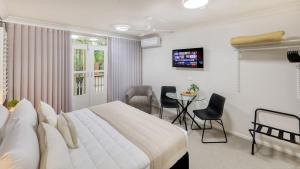 a bedroom with a bed and a table and chairs at Heritage River Motor Inn in Grafton