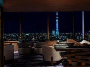 a room with a view of the eiffel tower at night at Asakusa View Hotel in Tokyo