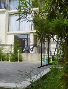 a house with a palm tree in front of it at Belgrad Rustaveli Kobuleti in K'obulet'i +1 photo