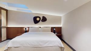 Postel nebo postele na pokoji v ubytování Hotel Trianon