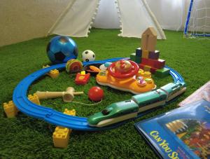 a childs toy train track with toys and a soccer ball at HOSHIYA Kamifurano in Kami-furano