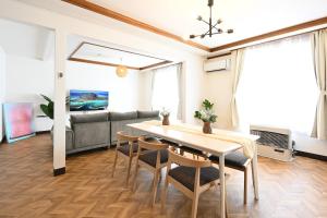 a living room with a table and chairs and a couch at HOSHIYA Kamifurano in Kami-furano