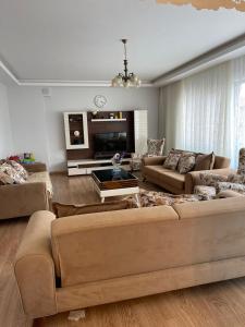 a living room with two couches and a tv at Duplex Apartment in Yalova in Yalova