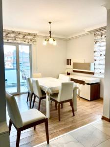 a living room with a table and chairs and a piano at Duplex Apartment in Yalova in Yalova