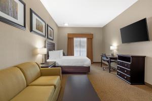 a hotel room with a bed and a desk at Best Western Bonnyville Inn & Suites in Bonnyville
