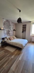 a bedroom with a large bed and a brick wall at Gîte Le repos du voyageur in Mary +31 photos