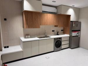 a kitchen with a sink and a washing machine at شقة قباء in Medina