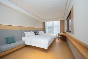 En eller flere senge i et værelse på JI Hotel Shanghai Jiaotong University Jinping Road