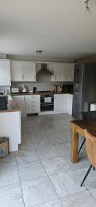 Hart's Place في Broughton Astley: مطبخ بخزائن بيضاء وطاولة خشبية +10 صور