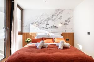 En eller flere senge i et værelse på Appartement 3P chic ski-in and out - Val Thorens