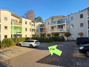 a car parked in a parking lot in front of buildings at Fewo unweit Warnemünde Sobierajczyk in Markgrafenheide in Rostock