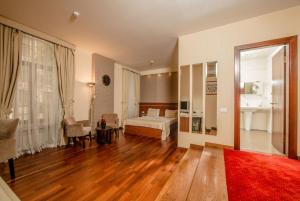 a bedroom with a bed and a room with a table at Art Passage Hotel in Baku