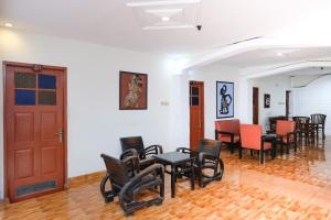 a room with chairs and tables and a door at RedDoorz at Hotel Raditia Graha Yogyakarta in Yogyakarta