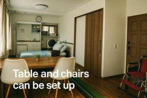 a room with a table and chairs can be set up at Barrier Free Guesthouse Support Include Free Parking Near AEON Mall in Osaka