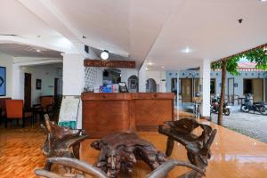 a wooden table with two chairs in a room at RedDoorz at Hotel Raditia Graha Yogyakarta in Yogyakarta