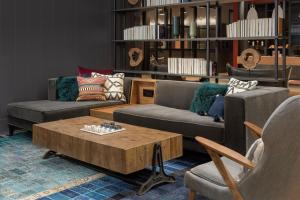 a living room with two couches and a coffee table at Canopy By Hilton Ithaca Downtown in Ithaca