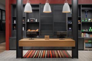 a counter in a store with two pendant lights at Canopy By Hilton Ithaca Downtown in Ithaca