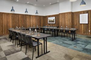 a conference room with a long table and chairs at Canopy By Hilton Ithaca Downtown in Ithaca