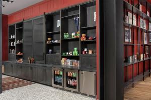 a bar with black shelves in a red wall at Canopy By Hilton Ithaca Downtown in Ithaca +31 photos