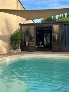 a swimming pool in front of a house at Studio en Provence in Graveson
