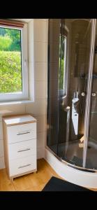a bathroom with a shower and a sink at Solina domki-„Solińskie wzgórze” in Solina +72 photos