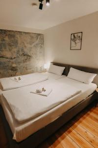 En eller flere senge i et værelse på Fachwerk Loft - Parken - Balkon - Appartement am Kocher & Stadtpark