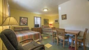 a bedroom with a bed and a desk and a table at Valentine Lakeside in Kingsland