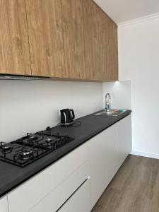 a kitchen with a stove top and a sink at White loft ЖК Престиж in Ternopilʼ
