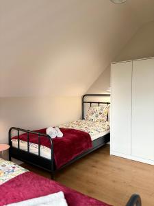 a bedroom with a bed and a white cabinet at Na Pańskim in Klimkówka