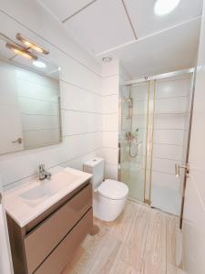 a bathroom with a sink and a toilet and a shower at LaMata Apartament in La Mata