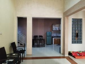 a living room with a kitchen and a dining room at Villa Kusuma Pinus M10 in Batu